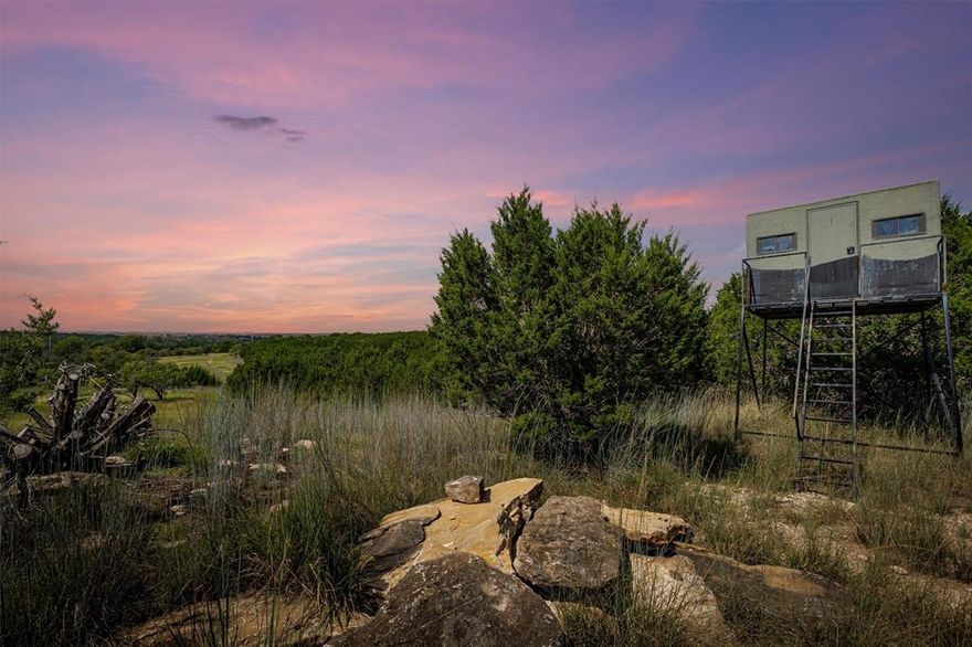 Lost Key Ranch - 324+ Acre High-Fence Hunting Retreat just two miles from Hamilton, TX. This hunting paradise is ideal for year-round living, personal getaways, guided tours and retreat or commercial investment. With diverse terrain, incredible views, abundant wildlife and modern amenities, the ranch offers exceptional outdoor experiences. Prime, yet private location, minutes from Hamilton Golf Club and local amenities. Superior hunting and wildlife; White-tailed Deer, Fallow Deer, Axis Deer, Wild Turkey, Dove and Hogs, managed under the Texas MLD program. Excellent water and wildlife habitat, rolling terrain, mature oak trees, a scenic year-round creek and multiple stocked ponds with Bass, Bluegill, and Catfish. Turn-key hunting set up with strategically placed blinds, feeders, and food plots to support game populations. Comfortable 1,200+ sqft barndominium with two queen bedrooms, loft that sleeps 6, covered back porch to relax and view the incredible sunsets, game and wildlife. The sheds, barn, storage containers, troughs, feeders, blinds and wifi tower convey with the property. The WiFi Tower offers full internet access for remote work and entertainment. Well maintained roads maximize access to the property and provide ATV and hiking trails. On-site substrate pit currently used as a shooting range. Road from FM 218 to the property is owned by the seller; gated access for security. Elevation from 1160ft to 1280ft. Hamilton ISD. House is on well. Approved Game Management Program. Fantastic future investment with the TXDOT Approved Expansion of US 281 (Relief Route) around Hamilton coming in the next few years.