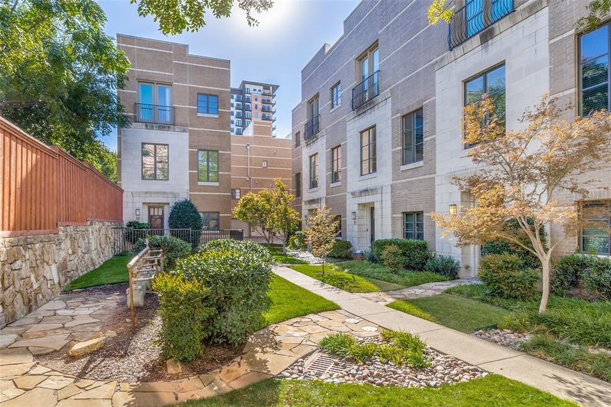 Nestled in the vibrant heart of Uptown just steps away from the scenic Katy Trail, this exquisite brownstone-inspired home at The Vine offers a perfect blend of classic charm and modern luxury. Built in 2006, this 2 bdrm 3 bath residence includes a versatile bonus room, ideal for a home office. It's a 3-Story home with 11-foot soaring ceilings, private rooftop deck, resort-style amenities & over 2300 SqFt of beautifully designed space. Rich chocolate cabinetry and quartz countertops throughout set the tone for elevated living. The open-concept layout features hardwood floors and a seamless flow between the kitchen, dining & living area, perfect for entertaining. The kitchen is a showstopper with oversized cabinets, large island, matching stainless steel appliances, built-in microwave, gas stove & walk-in pantry. Natural light pours in through windows on every level. The living area includes a built-in entertainment nook with a wine bar & wine refrigerator, adding a touch of luxury to your everyday. The large primary suite has a Juliet balcony, sitting area, private powder room with a spa-inspired bathroom featuring dual undermount sinks, oversized mirror, jacuzzi tub, separate glass shower, water closet, and spacious walk-in closet. Full-sized washer & dryer area conveniently located on the same floor. 2nd bedroom features its own private full bath, ideal for guests. Rooftop deck on 4th floor with panoramic views, invites you to enjoy sunsets, starlit evenings & unforgettable gatherings, with room to mount a flat-screen TV and hang string lights, it’s your personal open-air lounge. A rare Uptown find, and it's move-in ready. Additional highlights include attached oversized 2car garage & access to a resort-style pool with waterfall, all tucked into a quiet residential enclave, yet surrounded by the energy, elegance & connection that only Uptown can offer. You’re not just purchasing a property, you’re claiming a lifestyle. View all photo descriptions for more details.