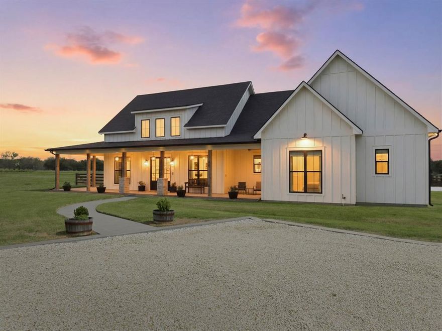 Exemplary design and craftsmanship by a custom home builder. This stunning home welcomes you with 8-foot mahogany doors, black double-pane windows, and antique hand-hewn posts and beams. The open-concept layout is filled with natural light from walls of glass, offering picturesque views of the surrounding property. The main home features 4 spacious bedrooms and 3.5 baths, along with a beautiful and elaborate 1 bed 1 bath guest house. The fourth bedroom is en suite and the only room on the second floor. This room could also serve as a flexible space for an office, game room, or second living area.The chef’s kitchen boasts a large island, a walk-in pantry with natural light, an upscale baker’s station, and high-end appliances including a five-burner gas cooktop. The kitchen sink is perfectly positioned to overlook the beautiful pool and surrounding acreage.
The isolated primary suite offers a spa-like bath with a walk-in shower and soaking tub, along with a walk-in closet that provides convenient direct access to the laundry room. Additional features include a 39×36 shop with drive-through access, three roll-up doors, and extra loft storage. 5.9 Acres with restrictions to allow horses and or livestock. Complete perfection in every way. Enjoy peaceful Texas sunrises and sunsets from the expansive wraparound porch—perfect for relaxing and taking in the scenic countryside.