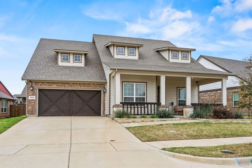 Welcome to this beautifully maintained one-owner home in the charming Somerset Park community of Rockwall. Built in 2019, this Craftsman-style residence immediately invites you in with its oversized front porch — the perfect spot for morning coffee or unwinding in the evening. Offering 2,384 sq ft, this thoughtfully designed layout includes 4 bedrooms and 2 full baths. Step inside to find a front bedroom that easily doubles as a home office. Subtle custom touches throughout the home add warmth and personality, making the space feel truly lived-in and loved. Continuing down the hall are two additional bedrooms and the first full bath. An updated mudroom area leads to the garage, adding everyday convenience and organization. The heart of the home is the open-concept kitchen, dining, and living area, ideal for both daily living and entertaining. The kitchen features a gas cooktop, stainless steel appliances, a wrap-around countertop with seating and a center island for extra prep space. A cozy breakfast nook overlooks the living room, where a gas fireplace creates a welcoming focal point. The primary suite is tucked away at the back of the home for added privacy, complete with an ensuite bath offering double sinks, a separate tub and shower and a spacious walk-in closet. Step outside to a large covered back patio and a backyard with plenty of room for a trampoline, playground or future outdoor projects. Somerset Park is a quaint, cozy community close to all of Rockwall’s amenities — including shopping, dining, and beautiful Lake Ray Hubbard — just in time to enjoy summer by the water.