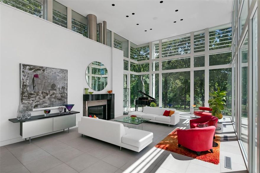 A stunning setting on rare 3.38 acres in the coveted Bluffview area of Dallas, featuring hard to find ONE STORY footprint, giving enormous scale and lifestyle to every room. This approx 9,000 sqft iconic estate has been the host for several movies and TV series, national commercials and publications, the gathering spot for many large community events, in addition to their everyday fun family living. Spectacular in everyway, the front gives off the quiet, private approach that was key to the location selection, while the interior and backyard's striking modern design w 6,000 sq ft of glass, 71,000 lbs of steel giving the most gorgeous unobstructed views of the spectacular nature and indoor-outdoor lifestyle surrounded by the tranquil creek setting. Renowned architect Guy Courtney skillfully designed patterns of Richard Meirer's work on the Getty Museum in LA in this estate, allowing the perfect backdrop for the seller's extensive art collection, large scale entertaining needs and resort relaxation atmosphere that takes in all the beauty year round. Wanting to be connected to the natural surroundings at every turn, the primary bath is a perfect example of pampering in the tree house like experience while enjoying all today's comfort amenities. The sellers took in their service staff input to design the gourmet kitchen w 3 ovens, 3 sinks and a silver cloth lined pantry for optimal entertaining needs. Lighting consultants evaluated every inch to ensure the perfect scene and zone control, acoustically pure media room, over engineered throughout, 3 ventilation systems protecting crawlspace, living area and roof, extra large limestone flooring blend inside and out seamlessly, and steel to hold the large 20 ft glass panes without mullions or columns in the corners for unobstructed views. A rare opportunity to own a celebrated Bluffview landmark in the most serene, tree-lined creek setting around.