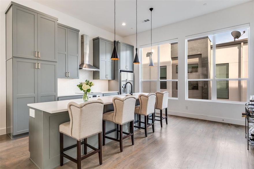 Experience elevated urban living in the heart of Dallas’ vibrant East Village. Built in 2020, this sleek three-story townhome offers the perfect blend of modern design and unbeatable location—tucked away on a quiet street while just moments from Knox Henderson, West Village, Lower Greenville, premier shopping, dining, and the highly anticipated The Central development.

The first floor welcomes you with a versatile flex space—ideal for a home office, workout area, or private retreat. Upstairs, the second level is designed for both entertaining and everyday living, featuring an open-concept layout flooded with natural light from expansive windows. The designer kitchen is a true standout, showcasing Arctic White quartz countertops, an oversized Platinum Gray island, Bosch stainless steel appliances, and custom soft-close cabinetry—all seamlessly flowing into the living and dining spaces.

The third floor is dedicated to rest and relaxation, featuring a spacious primary suite complete with a spa-inspired bathroom and a generous walk-in closet, along with a well-appointed secondary bedroom with its own beautifully finished bath and ample storage.

Thoughtful upgrades throughout include hardwood floors and motorized shades with blackout options in the bedrooms. Enjoy the ease of low-maintenance living with a private fenced front yard—perfect for pets, entertaining, or simply enjoying your own outdoor space in the city.

This is modern Dallas living at its finest—stylish, low-maintenance, and perfectly positioned.