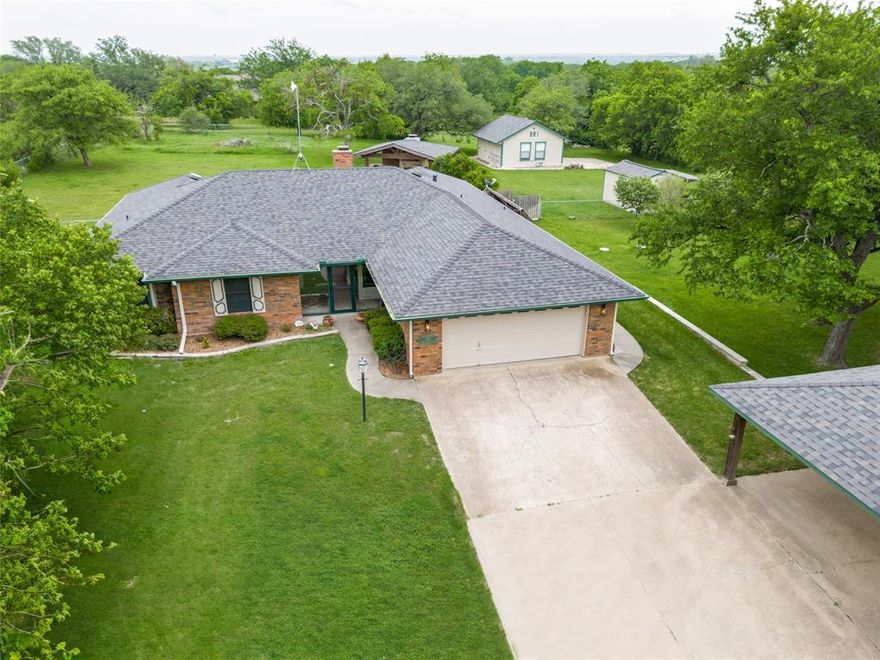 Perfect for that nesting feeling! It’s a comfortable neighborhood, secure brick house with its class 4 roofing, and with meticulous upkeep. You have privacy on over an acre of lightly wooded grounds outside the city limits. Convenience with stores and restaurants only 5 minutes away. Have fun in the pool, cooking in the outdoor kitchen, or sitting by a crackling fire. Fully fenced yard perfect for your kids or pets to run, play, and grow. If you like bird watching, wildflowers, and nature, this is the place for you.