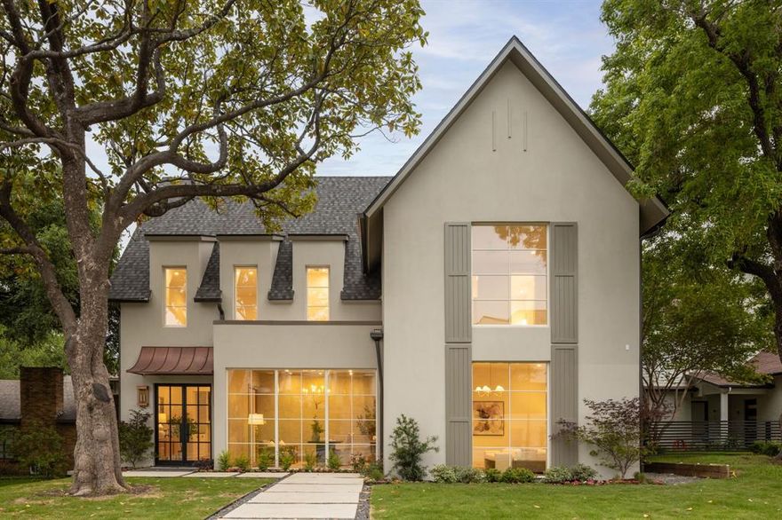 As featured on The Build Show Live, this exceptional residence by Jim Scott & Sons sets a new standard for modern luxury in Lakewood. A thoughtful blend of advanced building science and timeless architectural design, the home is ideally positioned along the storied fairways of Lakewood Country Club. Spanning just over 5,300 square feet, the home unfolds with intention and ease—every detail considered, every finish carefully curated. A steel front door beneath a copper awning opens to a striking entry with checkerboard marble floors and access to a sophisticated study-lounge through custom pocket doors. Wide-plank hardwoods and refined marble surfaces create a seamless flow through the primary living spaces. Expansive floor-to-ceiling Lincoln windows fill the interiors with natural light, while the living room—anchored by a center Isokern fireplace—connects effortlessly to the dining area and adjacent bar. The kitchen is both a visual centerpiece and functional showpiece, layered in warm wood tones, natural stone, and soft neutral textures, highlighted by a floating plaster range hood. A fully outfitted working pantry enhances everyday living and entertaining. A private guest suite and dedicated pool bath complete the main level. Upstairs, the primary suite is thoughtfully set apart, featuring a sitting room with custom built-ins and serene golf course views. An additional living area with integrated study space offers flexibility, while three secondary bedrooms each include en-suite baths and walk-in closets. Outdoors, a covered patio with fireplace overlooks the elevated backyard, designed with future pool plans in mind and supported by convenient pool bath access. Moments from the charm of Lakewood Village, White Rock Lake, and an extensive trail system, this residence offers a rare opportunity to experience one of Dallas’ most coveted neighborhoods through a lens of elevated design and performance-driven construction.Oversized two-car garage with lift capability.