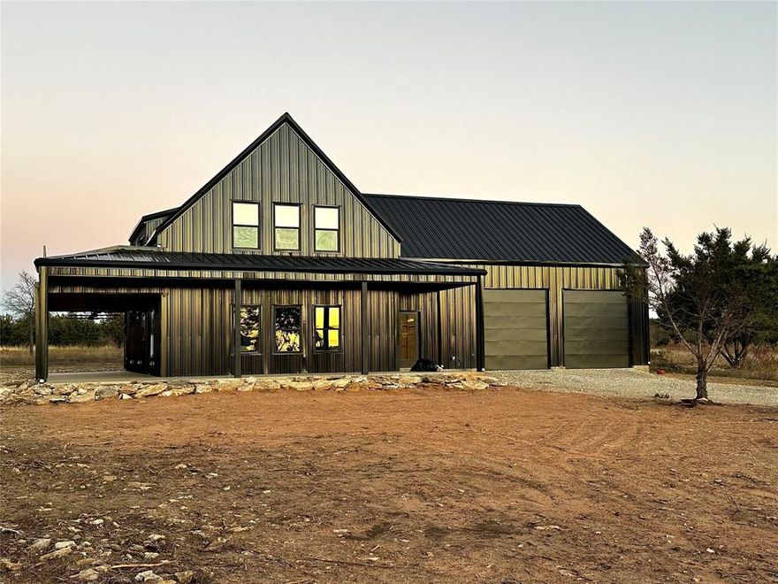 COMING SOON. Expected Completion Date December 18 2025.   Welcome to 1053 Bluff Creek Dr, a sleek modern barndominium designed for pure Possum Kingdom living. With Bold steel architecture, massive garage bays for boats and toys, huge covered patio, sunset balcony with Lake View and soaring cathedral style ceilings this property delivers style, function and lake lifestyle energy you won't find anywhere near this price.  Inside you'll find open concept great room, polished concrete floors, dramatic lofted bonus space overlooking main area and balcony access, modern kitchen.  Located in the heart of Sportsman's World near top the Marina, you have easy access to the Pool, Pavilion, Bluff Creek Marina.