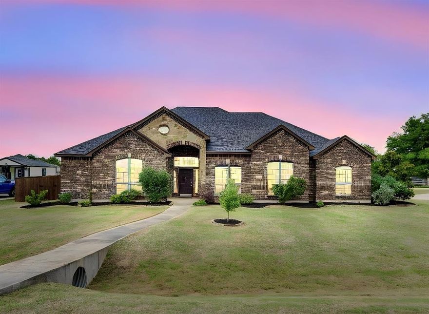 COUNTY TAXES AND NO HOA! CORNER LOT ON OVER HALF AN ACRE! Situated on a sprawling 0.60-acre corner lot, this meticulously maintained 2,741 sq. ft. traditional brick home offers the perfect blend of space and modern comfort. Built in 2014 and recently refreshed with new paint and refreshed landscaping! The Sellers fenced in the backyard and removed all carpet when they moved into the home. This home offers warm, natural light throughout. The interior shines with decorative lighting, durable luxury vinyl plank flooring with tile flooring in the kitchen and bathrooms. The heart of the home is a beautiful kitchen boasting ample space for all your cooking needs! The kitchen offers beautiful wood cabinets, a large island, an electric cooktop, a refrigerator, a stainless steel dishwasher, oven, and built-in microwave. The kitchen seamlessly flows into the eat in breakfast nook with wood blinds as well as into the formal dining area. Relax by the wood-burning fireplace on a cold winter night in the cozy living room, or retreat to the  private office for a quiet workspace. The functional split-bedroom layout includes a primary suite, two additional bedrooms, and an office. The sunny laundry room includes a wash sink and an electric dryer. The home internet service is through Starlink and the water system is through the Rocket Special Utility District. Outside, enjoy the freedom of a massive, fenced-in backyard with an extended back patio. There is a plum tree, a peach tree, a pomegranite tree, and plenty of room for chickens to roam! Also plenty of room to add a shop or a pool! Endless possibilities with no HOA! The 3-car garage offers room for all your vehicles or just a place to tinker. Located in the sought-after Waxahachie ISD and just minutes from local shopping, eateries, and entertainment, this property combines small-town charm with everyday convenience. Schedule your showing today! We'd love to show it to you!