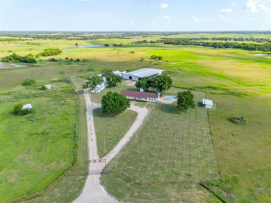 MOTIVATED SELLER!! 41+ ACRES; RANCH STYLE HOME WITH A POOL, PONDS & BARNS!! PERFECT FOR THE HORSE ENTHUSIAST AND CLOSE TO THE TEXAS MOTORPLEX, FOR CAR ENTHUSIASTS!! SOMETHING FOR EVERYONE!!  OUTSIDE THE CITY LIMITS!! LOWER TAXES......Escape the hustle and bustle of the city and embrace peaceful country living with this spacious 4-bedroom, 2 full bath ranch-style home situated on 41.18 acres of beautiful land!  Designed for comfort and function, the home features a welcoming wood-burning fireplace in the living room, with a hearth and wood mantel; a kitchen island and 2-dining areas, perfect for gatherings and plenty of room for family and friends.  The property is fully equipped for both relaxation and productivity. For those who need space to work and store equipment, the property offers 3 out-buildings, including two barns - ideal for livestock, hay or equipment storage - as well as a workshop with electricity... perfect for projects, car enthusiasts or hobby use.  Whether you are running cattle, starting a farm or expanding your opeartion, this property is designed to support a wide variety of uses.  You can also enjoy the Texas summer days by the sparkling pool, or quiet mornings on your large covered front porch, and evenings filled with BREATHTAKING SUNSETS stretching across the horizon.  Or taking a ride on your horses or your 4-wheeler, to the 2 ponds and just enjoy the expansive room to ride!  With over 41 acres to roam, this property offers endless opportunities for ranching, recreation, or simply enjoying the wide-open spaces.  Here, you can experience the best of country living - privacy, land, and freedom - all while still being within reach of modern convenience and entertainment.  Even enjoy motorsports events at the Texas Motorplex track ont 15-20- minutes from you.  This property truly has it all....room to work, play and enjoy the ultimate experience in country living!! AMAZING PRICE REDUCTION - MOTIVATED SELLER!!
