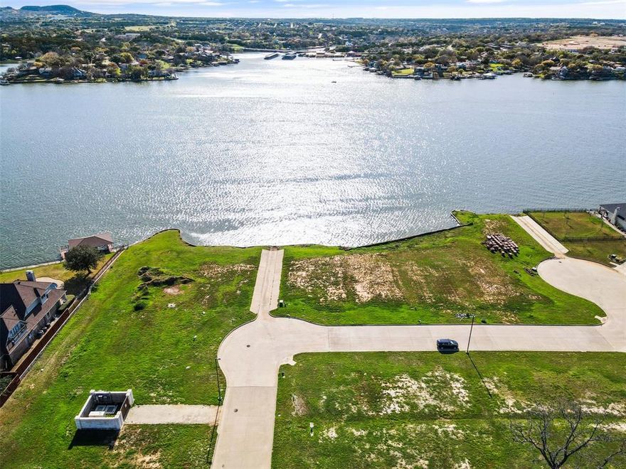 Welcome to your slice of lakeside paradise on the Fort Worth side of Granbury! Nestled in the tranquil Highland Park Bay, this build-ready lot offers the perfect canvas for your dream home. Boasting direct lake frontage, the property provides stunning panoramic views of the water, ensuring a serene and picturesque setting. Located just a stone's throw away from Stumpy's Marina, you'll have convenient access to boating, fishing, and all the recreational activities the lake has to offer. Builds must be at least 3000 square feet, the lot offers ample space to bring your vision to life, whether you're planning a cozy retreat or an expansive lakeside estate. Plus, with no age requirement for residents, this is the perfect opportunity to create a peaceful getaway or a forever home for your family to enjoy for generations to come. Don't miss out on the chance to own this prime piece of lakefront property in one of Granbury's most sought-after communities.