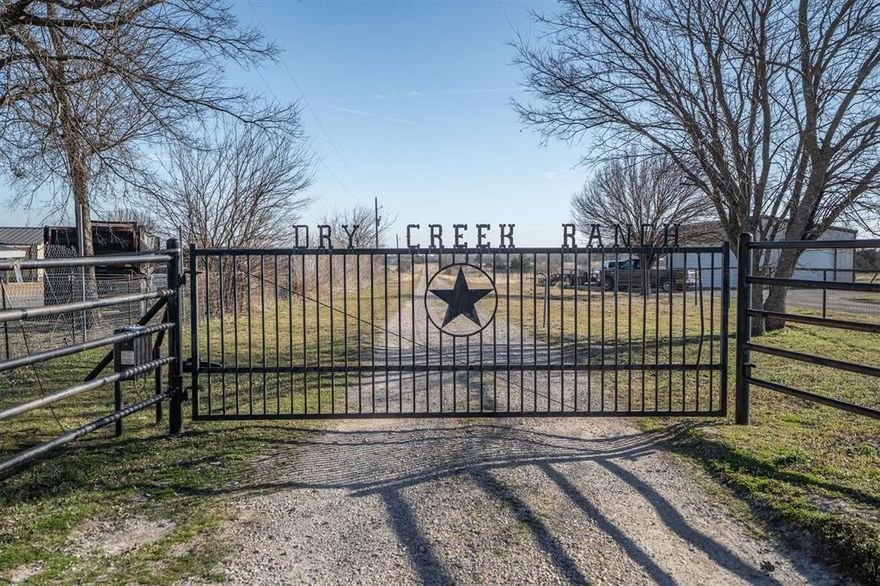 This 32-acre Texas ranch is the perfect blend of function and tranquility, offering everything you need for raising animals, storing equipment, or running a business from home. With an AG exemption already in place for 22-acres, the land is fully cross-fenced with no-climb fencing, featuring side and rear gates for easy access and livestock separation. Two spacious metal workshops provide endless possibilities. The 40x50 shop is fully insulated with spray foam and includes two 14ft automatic pull-through doors, making it ideal for storing an RV, large trailers, or heavy equipment. The 20x30 shop features a roll-up door and two overhang carports, perfect for additional storage or workspace. Whether you need room for tractors, feed, or a place to work on projects, these shops deliver both convenience and efficiency. At the heart of the property is a custom-built ranch home with a split floor plan offering 3 bedrooms, 2 bathrooms, and an oversized game room. The open-concept living area flows into a kitchen with stainless steel appliances, ample counter space, and stunning views from every window. The primary suite is a true retreat, featuring a walk-in closet, garden tub, dual sinks, and separate shower. With stained concrete floors and custom molding, the home combines rustic charm with modern convenience. Step outside to a covered patio with a swing, where you can sip your morning coffee and overlook your land. You'll enjoy the electric front gate to the property, 150amp house plug, high impact roof replaced in 2017, and interior paint in 2024. Enjoy your life at Dry Creek Ranch.