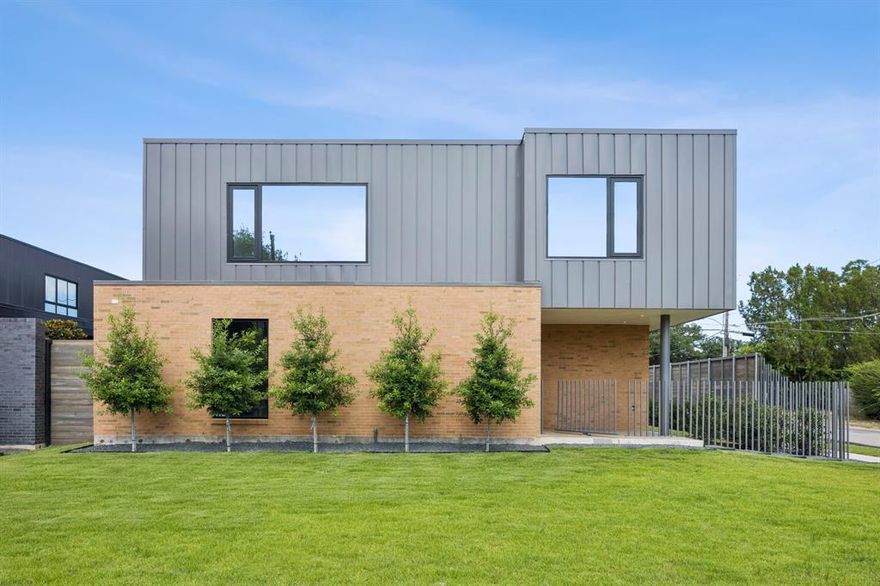 This architecturally significant home is the second in a series imagined by Joshua Nimmo and brought to life by AM Homes. A huge, green lawn welcomes guests as they marvel at the structure anchored by pink & brown bricks.  The clay bricks are the back drop between the green grass, 5 Eagleston Holly’s & grey metal framing the second floor of the structure. A hand-crafted metal fence magically sprouts from the ground looking more like a piece of art than the security it offers. Enter through a large pivot gate and admire the white oak door before entering this amazing home with diamond cut concrete floors. Inside white oak, floor-to-ceiling cabinets line the entry. The exterior clay brick returns inside to give a seamless transition. Rounding the corner you will find the main public space of the home. The living area is flanked by a 30’ span of floor-to-ceiling glass that looks out onto a covered, ipe deck and a large side yard specifically built for pool & sun deck!  The master suite is tucked in the back of the lot to offer complete privacy. The bedroom has its own private access to the future pool. The master closet is 25’ of glorious hanging space built with 24” deep white oak cabinets. The master bathroom, true to form, is framed by a 22’ span of floor-to-ceiling glass overlooking a zen garden with beautiful trees providing absolute privacy in a tranquil setting. Contact your favorite Real Estate Agent for a tour.