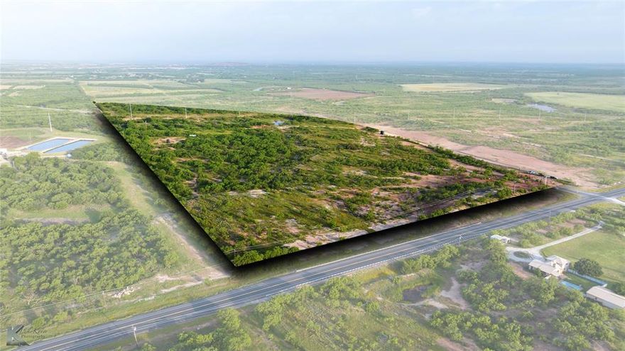 52.49 acres at the hard corner of East Lake Rd. and Neas Rd. with over 4,200 feet of paved road frontage—approx. 900 feet along East Lake Rd. and 3,300 feet along Neas Rd. Located just outside the Abilene city limits with access to city water and sewer and no zoning restrictions, this versatile property is ideal for residential, recreational, or commercial use.

Roughly 40 acres lie within the 100-year floodplain, but approximately 13.5 acres (5.5 acres along East Lake Rd. and 8 acres along Neas Rd.) are outside of the floodplain, offering great potential build sites. The land features a rolling terrain with elevation ranging from 1,670 to 1,640 feet near Buck Creek, which runs along the southern boundary. The property is fully fenced with 6-strand barbed wire and is currently used for grazing under an agricultural exemption. A ½-acre stock pond stocked with fish, plus whitetail deer, ducks, and doves, make this a great spot for hunting, camping, and outdoor recreation. There’s also an ideal location to build a 5-acre bass lake near Buck Creek. Soil types include Oplin-Vernon, Weymouth clay loam, and Rioconcho clay loam—supporting various agricultural or development plans. With prime location, road access, and utilities available, this is a rare opportunity to own a multi-use tract just minutes from Abilene. Whether you're looking to build your dream home, develop commercially, or create a private getaway, this property has it all.