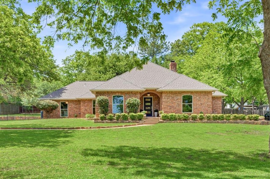 Located in beautiful northeast Keller, this fully updated home sits on nearly an acre and offers exceptional backyard privacy with an automatic gated driveway and no HOA restrictions. Inside, the home features four spacious bedrooms arranged in a desirable split floor plan, along with three full bathrooms, offering both comfort and functionality for everyday living. The oversized primary suite is thoughtfully positioned for privacy, while the secondary bedrooms provide flexibility for various needs.  The main living room serves as a welcoming centerpiece, highlighted by a beautiful brick fireplace, vaulted ceiling, and large windows that frame views of the private backyard. Natural light fills the space and creates an inviting atmosphere ideal for relaxing or gathering with family and friends. The fully remodeled kitchen has been thoughtfully designed with both style and functionality in mind. It features custom cabinetry, a Dacor gas range and addition built-in oven, walk-in pantry, and a cozy breakfast nook, creating a comfortable space. The layout flows seamlessly into the main living areas, making it ideal for entertaining. Just off the kitchen, the oversized dining room offers abundant natural light, a dedicated bar area, and plenty of room for hosting including a wet bar.  The home includes a two-car garage with a connected, enclosed storage space for additional organization and functionality. The expansive lot provides endless possibilities for outdoor living, whether enjoying the privacy of the backyard, creating a future pool oasis, or simply appreciating the extra space rarely found in this area. Conveniently located with quick access to Highway 114 and Southlake Boulevard (1709), the home also feeds into highly rated Florence Elementary and Keller High School, making it an excellent opportunity to enjoy both a prime location and top-rated schools.