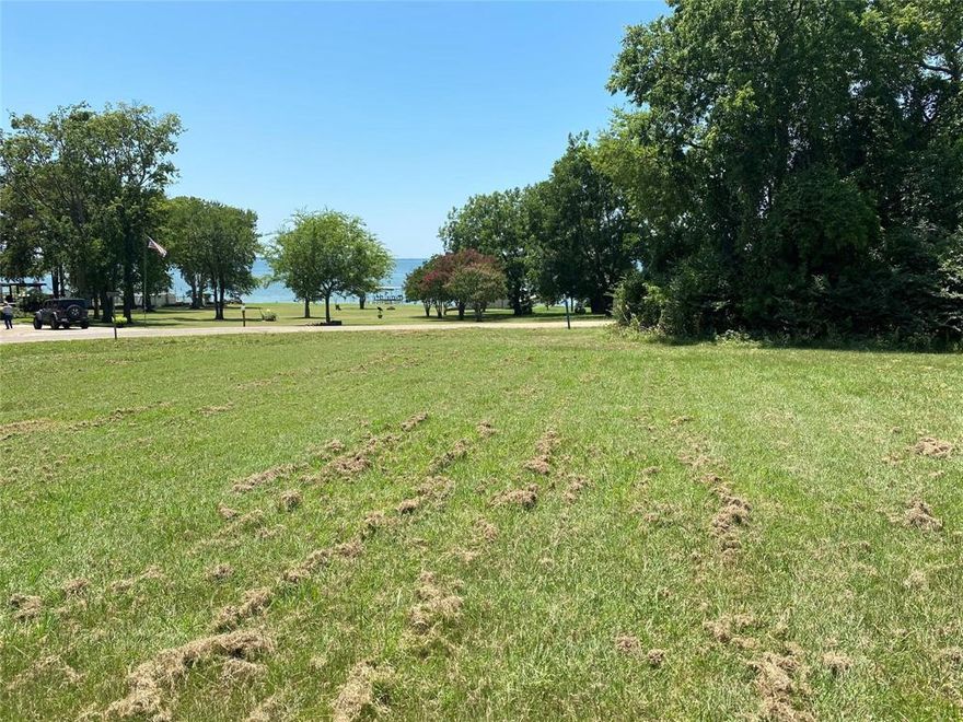Gorgeous lake views from this amazing large corner lot in Indian Hills neighborhood. Build your perfect lake getaway or full time home and watch the sunset off your front porch. One of the best remaining lots with park like views of beautiful Lake Tawakoni.  Quiet road with well maintained properties and recent custom home builds in area. Voluntary HOA has a community area with shoreline access nearby. City utilities available.  Rains ISD!