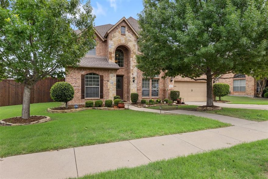 Location matters! You will love this elegant yet stately home set on a corner lot in the Chapel Hill neighborhood of Prosper. In a desired area near all the amenities and necessities a family will want while also not far from major roadways to make travel a breeze. Well cared for from the manicured landscaped yard to the warm wood flooring and neutral interior color palette. Open your front door to a soaring ceiling, spacious floorplan, and inviting views into major living areas. Off the entry, you will find office space overlooking the front yard. A few steps away, a rounding staircase, formal dining, and grand opening to the main family room. Large windows allow natural light to saturate main areas and each space seamlessly flows to the next. A stone fireplace adds a focal point for decor, conversation, or entertaining. The large eat-in kitchen with a breakfast bar, gas cooktop, double ovens, abundant storage, and ample counter space. Escape to your Primary Retreat with oversized en-suite and a walk-in closet to be envious of. The split layout has two bedrooms down and another two bedrooms up that share a connecting bathroom. Also upstairs you will find a game room and media room perfect for a hangout area. Downstairs is a large laundry room off the garage with extra storage. Don't forget the backyard with covered patio to enjoy that morning cup of coffee or evening conversation. The yard is spacious enough for play, furry friends, or gardens. This is a home that has something for every member of the family! Don't miss your chance to call it home.