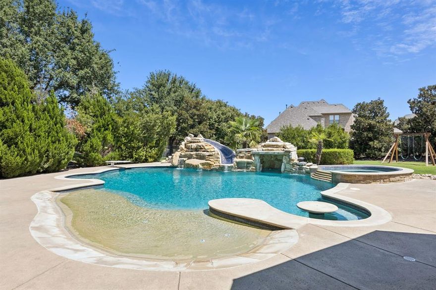 WELCOME TO YOUR DREAM HOME! Step inside this Stunning 5 Bed, 4.2 Bath, 3 Car with Porte-Cochere Home. This Custom Built Home blends Timeless Architecture with Modern Luxury. As you Enter the Grand Foyer, you are Immediately Drawn Through the Living Room to the Resort Style Pool, Perfectly Framed by Expansive Collapsible Glass Doors with Phantom Retractable Screen. From the Grand Foyer you will also notice 2 Romeo & Juliette Style Balconies & a Wine Room with Wine Fridge.  Raise Private Study Perfect for Work from Home with Hidden Room behind Bookcase. The Remodeled Kitchen Boasts a 6 Burner Gas Range with Griddle & Double Ovens, Porcelain Countertops & Abundant Space for Entertaining. The Primary Suite offers Beautiful Pool Views, Wood Floors & a Spa Inspired Bath with Dual Vanities, a Double Head Shower & a Spacious Custom Closet with Built-ins. An Additional Guest Suite Down. Upstairs, there are 3 Additional Bedrooms, One with its Own Work Area & Hidden Dressing Room or Flex Space. The Game Room includes Wood Floors, a Wet Bar & Juliette Style Balcony Doors that Open to the Covered Outdoor Patio. A Media Room with Stadium Style Seating Completes the Entertainment Spaces. Outside, your Backyard Oasis Awaits. 2 Large Covered Patios provide Space for Lounging & Dining, including an Outdoor Kitchen with Built-in Grill & Fireplace. The Pool is a True Showstopper, Complete with Waterfalls, Oversized Spa, Beach Entry, Built-in Picnic Table with Seating, Diving Board, Slide & Grotto. A Fenced Dog Run adds Convenience for Pet Lovers. All of this is Located in a Prestigious Neighborhood just 5 Miles from Southlake Town Square & 12 Miles from DFW Airport. A TRUE MUST SEE!