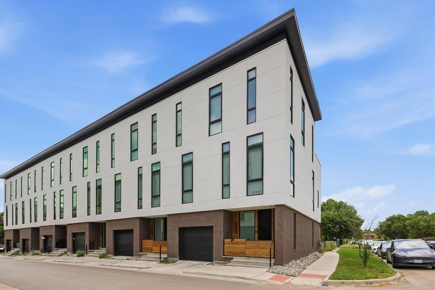 Experience elevated urban living in this modern, corner-unit townhome located in the heart of Fort Worth, just moments from Magnolia Avenue, South Main, and TCU’s medical school campus. Thoughtfully designed across three levels, this residence blends sophisticated architecture with refined luxury and exceptional functionality. Each floor features a private bedroom and bath, offering the ideal layout for guests, roommates, or multi-generational living. The expansive main living level is anchored by a dramatic waterfall island, quartz countertops, sleek custom cabinetry, and premium stainless steel appliances — all seamlessly connected to an open-concept living and dining space designed for effortless entertaining. Retreat to the secluded third-floor primary suite, where a custom walk-in closet and spa-inspired bath create a true sanctuary. Indulge in dual sinks, a freestanding soaking tub, and frameless glass shower. A conveniently located third-floor laundry room enhances everyday living. The rooftop patio delivers breathtaking panoramic views of the Fort Worth skyline, offering an unforgettable setting for entertaining or relaxing under the city lights. Additional upscale features include electronic shades throughout, privacy window film, and a tandem garage with epoxy flooring. With no HOA and short-term rentals permitted, this exceptional property presents a rare opportunity for both luxury living and investment potential in one of Fort Worth’s most dynamic locations.