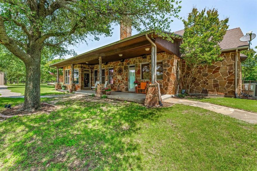 This private, peaceful 13 acre oasis in Parker County has it all! This premier horse property provides just the right amount of room for all your favorite outdoor activities while nestled behind the protection of a fully tree lined views. There is abundant wildlife and a natural pond that adds to the enjoyment of this beautiful property, so be sure to grab a fishing pole. As you enter the back of the property, a full sized, lighted tennis and pickleball court along with a 140 yard PGA designed Par 3 Tee box, green, sand traps, and water features provide a beautiful view! An amazing custom built 130'x 300' arena comes with a solar powered remote operated Priefert roping chute. The 2-stall horse barn with outdoor runs sits in front of the arena. There is an additional 4 stall concrete foundation to build out as desired for more horse stalls or dog kennels. An exceptional 50 x 120 4 door shop with RV hookups will protect your trailers and important equipment. The shop includes a private office or bedroom with full bathroom with custom Saltillo tile. There is a large air compressor in the shop which is piped throughout for easy access. The custom flagstone 3 bedroom, 2.5 bath home has additional living spaces for an office, dining area or extra guest rooms. A large master suite offers a beautiful view of the property and features large walk-in closets and vanities for both him and her. There is a generous storage throughout the house and kitchen. An outdoor covered patio behind the home is a great space for entertainment and offers a peaceful space to enjoy your evenings! Come take a look and make this your very own! Don't delay as a property like this is surely not going to last long!!