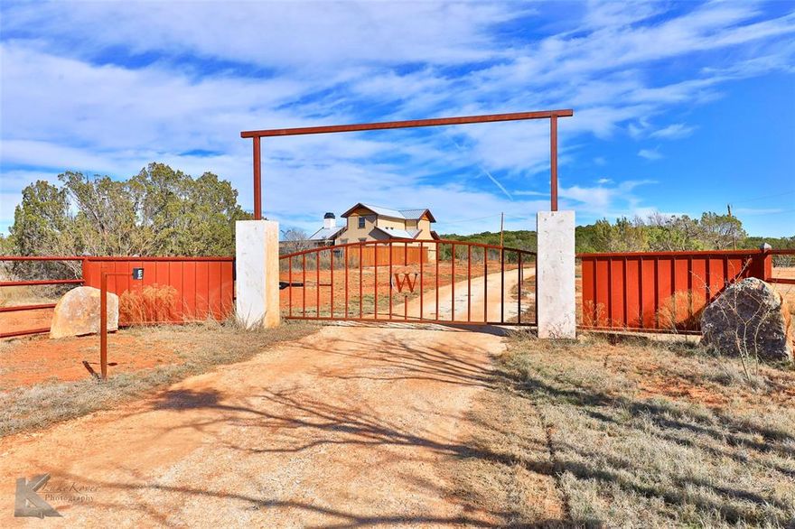 Here's your chance to own a slice of west Texas country paradise! Panoramic views create a dramatic back drop & some of the best sunsets Taylor county has to offer. Bring your animals; cattle, goats, horses & more & create the hobby farm of your dreams! Large tank has idyllic fishing pier & is stocked with crappie & catfish for easy grocery getting! Enjoy coffee on the sprawling front porch from the enjoyment of your built in porch swing. Open concept home has incredible finishes including real wood floors, eye catching wood beams & wood burning fireplace with decorative wood storage. Well equipped kitchen has counter space galore & hand crafted wood cabinets. 1st floor primary offers privacy with walkin closet & en suite bath with dual sinks, walkin shower & relaxation tub. 2nd story offers loft area, perfect for play or 2nd living. Spacious bedrooms have views galore & share brand new bath with striking tile details. Lastly, huge 2 bay insulated shop with electric for all your needs!