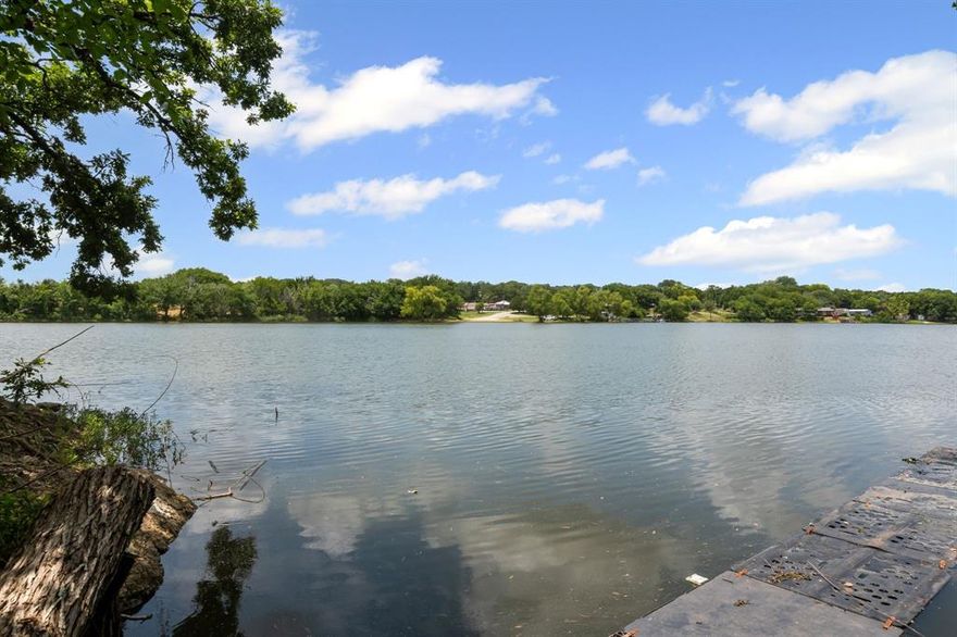 Want to live next to the water with a beautiful view of the lake and nature? This Spanish Style Oasis offers it all! This home combines timeless charm with modern comfort. Featuring a classic stucco exterior, 4 Bedrooms, 3 bathrooms and scenic Western lake backdrop, it's the perfect blend of privacy, style and relaxation. Inside you'll find a spacious living room, a dedicated home office and thoughtfully designed bedrooms ideal for family or guests. Step out onto the private second-floor balcony to enjoy peaceful surrounding, or entertain with ease on the large covered patio. The beautifully landscape yard and carport with space for up to 3 vehicles add convenience and curb appeal. Best of all you'll have direct access to Western Lake with a step down pathway-perfect for unwinding by the water or launching a small watercraft. With a private electronic gate for added security, This home is ready to welcome you into lakeside living at its finest.