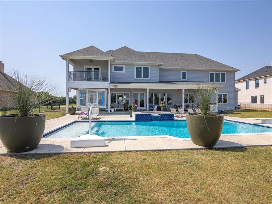 Eagle Mountain Lake LAKESIDE PARADISE complete with DOCK, POOL, & OUTDOOR KITCHEN! Enjoy year round Lake Life that feels miles away, but just 25 minutes to Fort Worth & TCU! Incredible views & waterfront breeze you’ve dreamed of! Designed to entertain, this CUSTOM HOME features a resort style diving pool & spa, new DOCK w LIFT, HUGE CHEFS KITCHEN w custom cabinetry, granite island, lg walk-in pantry & adjoining wet bar. Open concept layout w lower floor including 2 living spaces w 2 fireplaces, kitchen, dining & pane-glass workout or flex room plus 2 rooms used as office & guestroom or Mother-in-law suite! Upstairs boasts 2 en-suite bedrooms, a huge primary suite w spacious bathroom w double shower, soaking tub, walk-in closet & balcony, plus a Great Room Suite incl. bonus room & lg storage closet! Almost 1 acre in gated community w adjoining green-space to see tons of deer & beautiful views! Oversized 3-car garage for a large truck (1400 sqft), foam insulation means energy efficient!