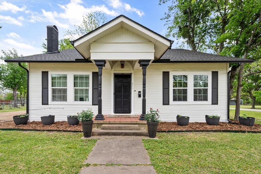 Step into a home that truly feels like it has a story to tell—where early 20th century character meets thoughtful modern updates in all the right ways. Built in 1930 and nestled on a spacious corner lot in Kerens, this 3-bedroom, 2-bath Craftsman blends timeless architecture with modern farmhouse touches, creating a warm and inviting space that feels both nostalgic and refreshed.  

The classic front porch sets the tone—perfect for slow mornings, evening conversations, and soaking in the charm of a simpler time. Inside, original hardwood floors flow throughout much of the home, beautifully complemented by updated finishes, decorative lighting, and a cozy brick fireplace that anchors the main living space. The layout offers both comfort and function, with spacious living and dining areas filled with natural light and character-rich details at every turn.

The kitchen is a standout, featuring a farmhouse sink, granite countertops, built-in cabinetry, and a walk-in pantry—blending vintage inspiration with modern convenience. Every space feels intentional, preserving the soul of the home while making everyday living easy.

Outside, a living, breathing garden retreat designed for those who love to grow, nurture, and harvest. Thoughtfully designed raised garden beds, established planting areas, and curated landscaping create a turnkey setup for the green thumb enthusiast. Whether you envision harvesting fresh vegetables, cultivating herbs, or simply enjoying the rhythm of seasonal blooms, this property offers the infrastructure and space to make it happen. It’s a home that keeps on giving—rewarding its next owner with beauty, purpose, and the potential for homegrown abundance year-round.  

This property delivers the perfect blend of charm, creativity, and livability. If you’ve been searching for a home with personality, history, and a place to truly put down roots—this one is ready to grow with you.