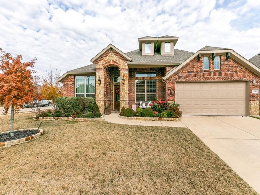 THIS STUNNING AND COZY 3 bedroom, 3.5 bath home on a large corner lot will not last long! This home features a spacious private primary suite with separate shower and relaxing garden tub; double vanities, and walk-in closet.  Read a book by the fire in the living area that overlooks the gorgeous, covered patio with its own fireplace, perfect for entertaining! The kitchen, with warm wood cabinets, features tons of granite counterspace, built in microwave and double ovens, large pantry, and room for a mobile island. The 2nd and 3rd bedrooms come complete with full bathrooms and large closets. The private office with french doors could be converted into another bedroom and the formal dining room can also be used as an additional living area if desired. Attic space in garage is floored. The recently installed 8-foot BOB fence provides privacy for the outdoor living space and gardens.  
Rockwall ISD. HOA Community includes 2 pools, gym, dog park and green spaces. Buyer to verify info.