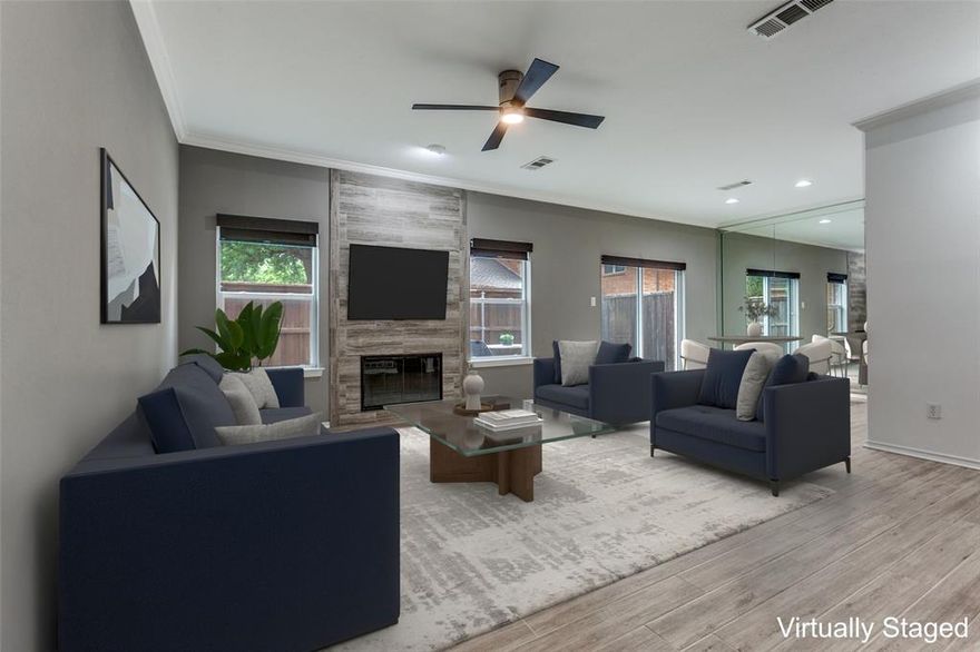 Welcome to this beautifully updated, low-maintenance end-unit townhome in desirable North Dallas. Designed with both style and functionality in mind, this 2 bedroom, 2.5 bath home offers an inviting entry with gorgeous wood-look tile flooring that flows throughout the main living areas. The spacious living room is perfect for gathering, featuring a cozy wood-burning fireplace with a floor-to-ceiling tile surround, flanked by two windows that fill the space with natural light. The dining area seamlessly connects to the galley-style kitchen, which is equipped with GE stainless steel appliances, granite counter-tops and backsplash, under-cabinet lighting, and a pantry. A convenient half bath is located on the first floor, ideal for guests. Upstairs, the primary suite offers an updated ensuite bath and a walk-in closet. A secondary bedroom also features its own ensuite bath and walk-in closet, providing comfort and privacy for all. Step outside to your private outdoor retreat with a stone-paved patio—perfect for relaxing at the end of the day. Residents enjoy access to a recently renovated community pool, along with convenient proximity to major highways, shopping, and dining. Washer, sewer and trash included in HOA dues.