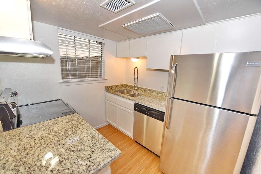 Unit features; wood burning fireplace, kitchen bath room and half bath room granite countertops with under mounted sinks.  Stainless steel appliances and one assigned covered parking space. NEW Berber carpet on 2nd floor in two bed rooms, ceramic tile in kitchen, half and full bathroom, 1st floor has faux wood vinyl,  hardware and ceiling fans.  WD included.  Nice fenced patio and small complex with gated community.