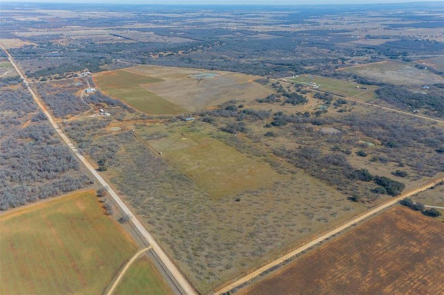 Perched atop a scenic hill with breathtaking panoramic views, this extraordinary 305-acre high-fenced ranch is the definition of Texas luxury and privacy. Outdoor functionality meets ranch practicality with: Oversized detached garage with workspace and 50-amp plug; covered outdoor cooking area; dedicated meat processing room and storage; 25x22 carport.
The property is completely high-fenced and cross-fenced, currently home to approximately 40 Fallow Deer and 17 Red Deer — making this a turnkey recreational, hunting, or investment opportunity.
The 3000 sq ft custom home commands the landscape, offering sweeping views from an expansive front room that stretches the full length of the house. Bay windows frame the countryside while a wood-burning fireplace creates the perfect setting for quiet evenings overlooking your land.
The chef’s kitchen features custom pecan cabinetry, granite countertops, a farm sink, and a large island that flows seamlessly into the living area anchored by a wood-burning stove — ideal for gathering after a day outdoors.
The primary suite is thoughtfully designed, including a walk-in closet with a built-in secure gun safe room reinforced with metal plating. A vaulted-ceiling man cave houses a Family Safe tornado shelter, blending comfort and security. 
Whether you’re seeking a private family retreat, corporate getaway, hunting ranch, or long-term legacy investment, this remarkable property delivers.
Conveniently located less than 90 minutes from DFW, yet worlds away from city life.
Opportunities like this are rare. Schedule your private showing today.