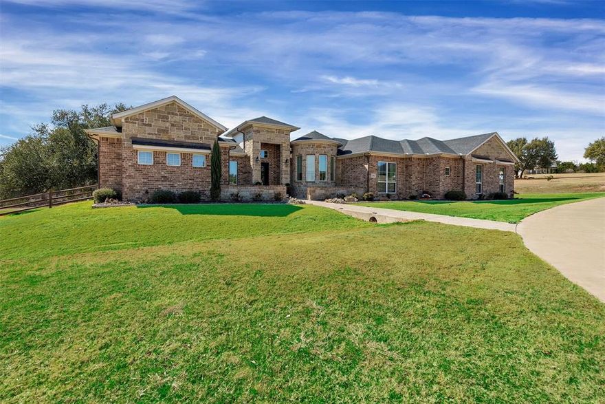 Tucked away on 2.1 picturesque acres in the coveted Rolling Creek Ranch community of Granbury, Texas, this exceptional custom-built home offers a rare blend of refined luxury, thoughtful design, and serene country living. Boasting four spacious bedrooms and four beautifully appointed baths, the home is perfectly suited for both everyday comfort and elegant entertaining.  As a bonus, primary bath includes a dedicated closet with stackable washer-dryer hookups or space for a gun safe.  
At the heart of the residence is a chef’s kitchen designed to impress, complemented by an oversized pantry, a dedicated wet bar area, and seamless flow into the main living space— showcasing tranquil views of a mature pecan orchard. A separate private office provides an ideal work-from-home retreat.
Step outside to your own resort-style oasis, where a sparkling pool controlled electronically by a phone app, is framed by mature trees that create a stunning natural backdrop while ensuring exceptional privacy. A covered porch with an outdoor grilling area along with a stone fire pit that invites year-round entertaining and relaxed evenings under the Texas sky.  
With its unparalleled setting, thoughtful layout, and one-of-a-kind charm, this remarkable property offers a lifestyle that is both elevated and peaceful—truly a rare find in today’s market.  Neighborhood has two entrances for easy access.