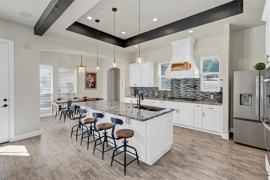 This house comes with a REDUCED RATE as low as 4.875% (APR 5.376%) through List & Lock™. This is a seller paid rate-buydown that reduces the buyer’s interest rate and monthly payment. Terms apply, see disclosures for more information. This exceptional custom-built home on 2.1 acres offers a rare blend of refined luxury, thoughtful design, and serene country living. Boasting four spacious bedrooms and four beautifully appointed baths, the home is perfectly suited for both everyday comfort and elegant entertaining.  As a bonus, primary bath includes a dedicated closet with stackable washer-dryer hookups or space for a gun safe.  
At the heart of the residence is a chef’s kitchen designed to impress, complemented by an oversized pantry, a dedicated wet bar area, and seamless flow into the main living space— showcasing tranquil views of a mature pecan orchard. A separate private office provides an ideal work-from-home retreat.
Step outside to your own resort-style oasis, where a sparkling pool controlled electronically by a phone app, is framed by mature trees that create a stunning natural backdrop while ensuring exceptional privacy. A covered porch with an outdoor grilling area along with a stone fire pit that invites year-round entertaining and relaxed evenings under the Texas sky.  
With its unparalleled setting, thoughtful layout, and one-of-a-kind charm, this remarkable property offers a lifestyle that is both elevated and peaceful—truly a rare find in today’s market.  Neighborhood has two entrances for easy access and as a bonus there are no city taxes.