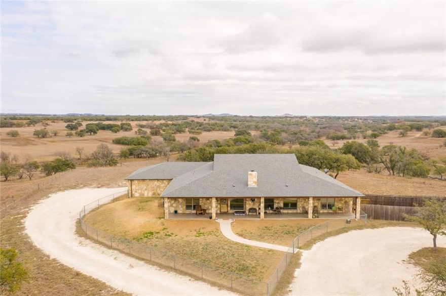 6001 FM 1690 offers the chance of lifetime! Own 555.77 acres of prime native pasture with two residences, a ranch operation, a full-mile of Bee House Creek access, abundant wildlife, & more. 6001 FM 1690 is complete with: four stock tanks, two water wells (electric pump & windmill), an 8-stall metal horse barn with runs and paddocks, cattle barn with pipe lots and chutes, two 2-sided grain bins, a 30' X 80' hay barn, 20' X 30' shop, a ranch hand tenant house, plus full fencing. Surface and mineral rights will convey; there are 100 acres of native field stone and a rock storage shed. Constructed in 2014, the main house (4 Bed/2.5 Bath) boasts of a 8' X 70' front porch and 18' X 100' rear porch; perfect for enjoying Hill Country's finest panoramic views. Ceramic tile throughout the home makes cleaning a breeze. There are also 2 water heaters, 2 walk-in showers, a garden tub. The exterior stone veneer comes straight from the ranch. Passive income opportunity also available with the secondary rental home (4 Bed/2 Bath). Ranch hand dwelling is a 1 bedroom, 1 bathroom space.