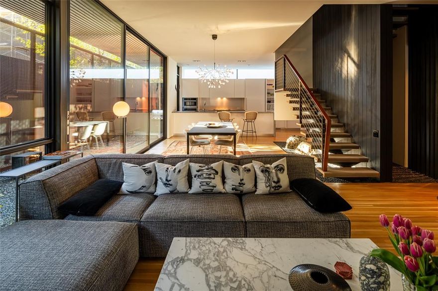 Designed by award-winning architect Cliff Welch and Rick Fontenot with Constructive in 2016, this single family attached home sits on a tree-lined property nestled in charming Northern Heights, just minutes from the Katy Trail and Knox Henderson. Inspired by Japanese architecture, Welch incorporated steel, stucco, and Douglas fir in the 4,117-sqft home to create a spacious, 3-story floorplan featuring 3 bedrooms, 4.1 bathrooms, 2 living areas, a 2-car garage, and elevator access to all levels. Find a family room that opens to the dining room and kitchen, which is outfitted with Miele appliances and Eggersmann cabinetry. A floating staircase takes you to the 2nd level, which includes 2 guest rooms with ensuite baths and a primary suite boasting a seating area, a spa-like bathroom, and a palatial walk-in closet. A spacious second living area on the third floor can also be used as a home office, fitness room, or guest suite and opens to large rooftop deck, wet bar and treetop views.