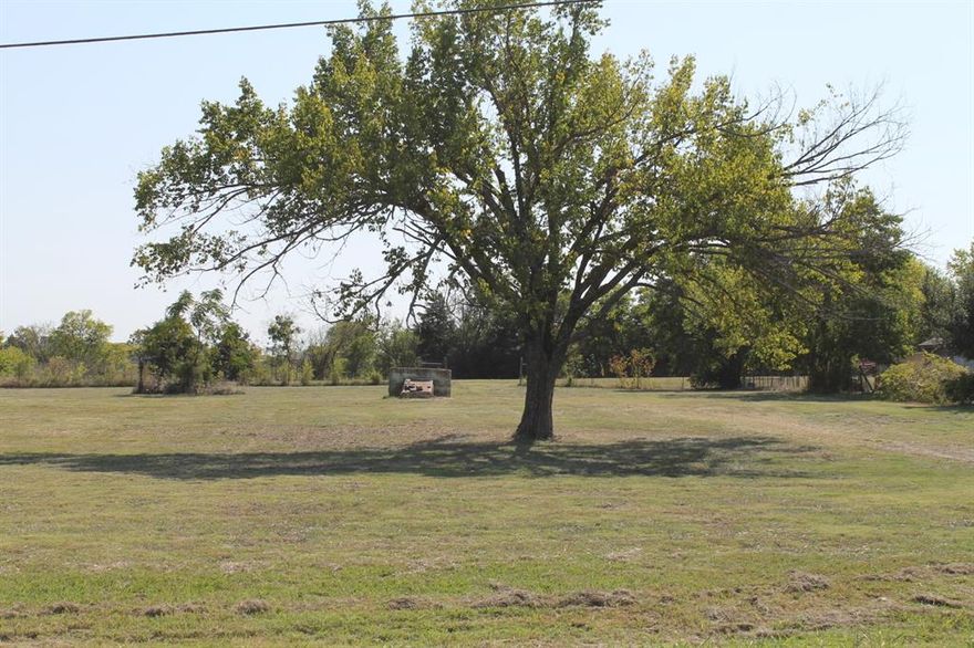 Nice tract of land inside the City Limits. Property has Road frontage on FM 272, just off Hwy. 69. Property is partially fenced, has good grass, a few trees , loafing shed, and old storm cellar. Be advised this tract shows to be lots 5-8 , .2726 Ac.  on tax appraisal information, but new survey indicates the tract to be 1.911 acres. See Tax information in media section. The lines drawn in on the Tax map are approximate. Buyer and or Buyer's representative is responsible for obtaining any and all information regarding Utility availability and information from the City and or County regarding use of the property.