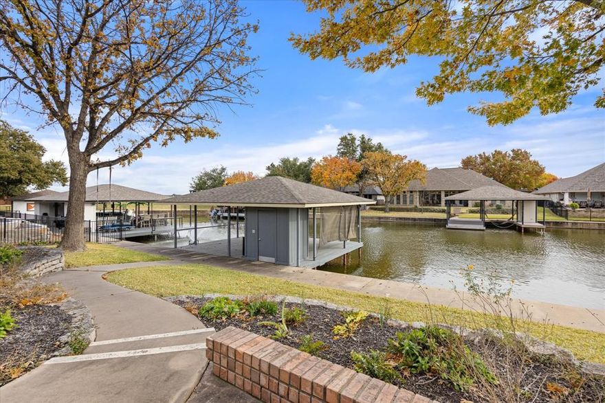 Massive Price Improvement!  Wouldn't it be great to have free electric bills!  This house delivers with almost new solar system.  Run the HVAC as much as you want and discover what solar can do. Discover lakeside living at its finest in this exceptional one-story brick home nestled in Granbury, TX. Boasting a smart layout that spans 2,454 square feet, this residence offers four cozy bedrooms and two well-appointed bathrooms. The primary bedroom, split from the others for privacy, features access to the serene outdoor spaces. Step into the heart of the home via an open kitchen, complete with stainless steel appliances, custom white cabinetry, and a large island equipped with a secondary sink — perfect for those who love to entertain or simply enjoy culinary adventures. Adjacent to the kitchen, you’ll find a convenient utility room with its own sink and ample cabinetry. The enclosed back patio provides an additional space for gatherings, while large windows throughout the home flood the spaces with natural light. Outdoors, the meticulously maintained landscape surrounds a transformed boat dock, now a relaxing lounging deck overlooking the lake. The dock is very easy to revert back to a boat dock,  it promises endless water fun.