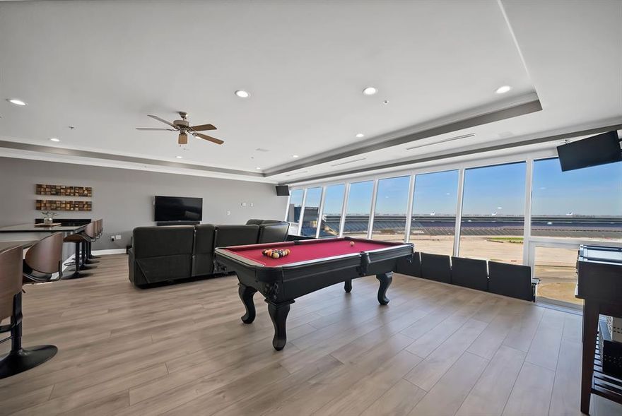 Priced BELOW value! Motivated seller! Experience race weekend like never before from your 9th-floor luxury condo overlooking Turn 2 at Texas Motor Speedway. This fully upgraded 2-bed, 2-bath residence was designed for both comfort and unforgettable entertaining. Floor-to-ceiling windows showcase sweeping track views, complete with electric shades. Inside, 14 stadium-style seats line the window, giving you a private, climate-controlled viewing experience unlike anything else at the speedway. The open-concept living area features two oversized bartops perfect for hosting, along with a built-in wine fridge and beverage fridge to keep refreshments flowing all race weekend long. Ownership includes 8 tickets to every race, making this the ultimate motorsports retreat. Just in time for the major NASCAR race weekend May 1st! Community amenities elevate the lifestyle even further with access to a resort-style Texas-shaped pool, clubhouse, fitness center, tennis court, pickleball court, and basketball court. LIVE ABOVE THE ACTION. ENTERTAIN IN STYLE. OWN THE ROAR...Prefer it turnkey? Furnishings are negotiable.