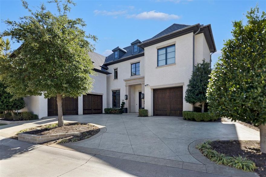 Step into sophistication with this exquisite residence nestled in the desirable gated and guarded community of the Lawn at Glen Abbey in North Dallas. The home offers modern finishes, open-concept living, and a layout designed for both daily ease and elevated entertaining. A grand interior welcomes you. Imagine a sweeping entry, high ceilings, and a beautifully appointed great room that flows seamlessly into the gourmet kitchen featuring high end Wolf appliances. The kitchen is designed for both form and function with premium cabinetry, a generous island for gathering and space to host lively dinner parties or casual breakfasts. Featuring two primary suites, one on each level, this home delivers versatile living arrangements ideal for in-laws or extended guests. The lounge area blends warm modern design with elevated functionality. Rich wood cabinetry with sleek brass hardware offers abundant storage, while dramatic stone countertops with striking veining create a bold, luxurious focal point. A built-in beverage cooler and ice maker set the stage for entertaining. The media room is equipped with surround sound and is ready for family movie night. Step outside to a backyard built for connection, where a refreshing pool and spa invite you to unwind, an outdoor grill makes hosting a breeze, and a glowing fire pit sets the scene for memorable evenings with friends and family.