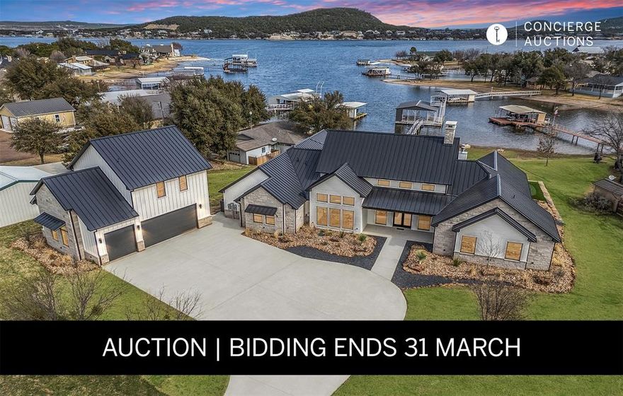AUCTION BIDDING OPEN! Bidding ends on Tuesday, March 31st. Previously Listed $4,990,000. Current High Bid $2,500,000. An exceptional lakeside estate awaits within the exclusive gates of Gaines Bend on Possum Kingdom Lake, where refined Texas luxury meets the dramatic beauty of canyon country. This custom Bret Jordan masterpiece delivers uncompromising sophistication across over five thousand square feet, featuring a thoughtfully designed floor plan with a serene primary suite, four beautifully appointed guest rooms, and a separate mother-in-law suite. A stunning bunk room crowns the detached three-car garage, complete with private coffee bar. The gourmet kitchen showcases premium appliances and custom cabinetry, flowing seamlessly to a game room and full bar. Outside, a resort-caliber oasis unfolds with sparkling pool, firepit, and multiple covered patios. A private two-level dock in a tranquil cove provides instant access to world-class boating and water sports.
