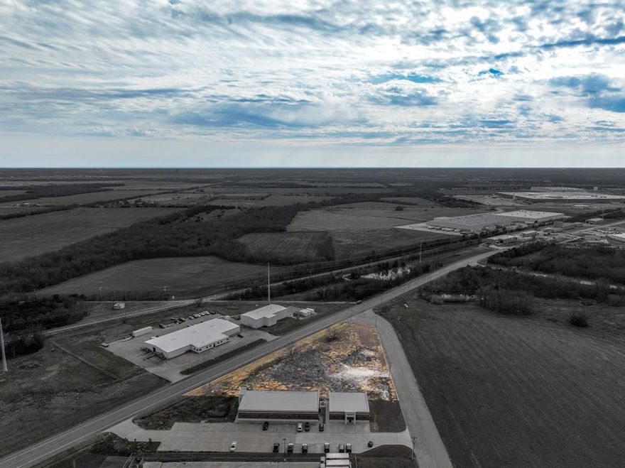 A prime 1.143-acre lot is now available for sale in Greenville, TX, ideally located within the city’s southwest Industrial District. This strategically positioned property is zoned for industrial use, offering significant potential for a wide range of business operations. The property is strategically located at a prominent corner with over 400 feet of frontage along State Highway 66, offering exceptional visibility and convenient access to major transportation routes, including Highway 380, less than half a mile away. The property is equipped with essential utilities on-site, including City Water, City Sewer, and electricity, making it a convenient and ready-to-build location for industrial development. This area is home to a variety of established businesses, including CNH America, Solvay Composite Materials, Rhino Linings, and several others, further enhancing the property’s appeal as part of a thriving industrial hub.