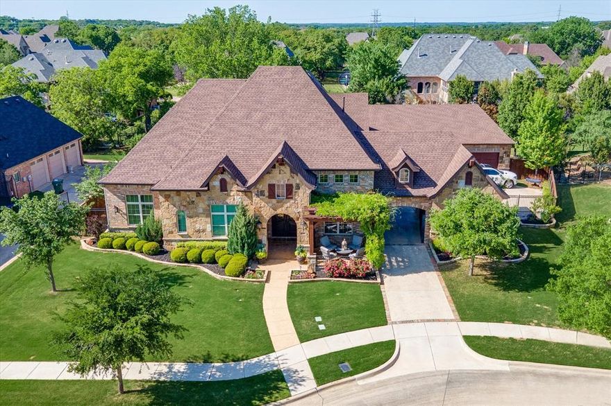 Stunning stately home on lush manicured grounds in Carillon of Southlake. A welcoming front porch & oversized iron doors draw you into this flowing floor plan with a grand entry, executive study, wine room & formal dining room with butler's pantry. Sprawling living room hosts a warm fireplace & opens to the gourmet kitchen with a vast island, gas range & walk-in pantry. Breakfast room has additional storage & accompanied by game room with wet bar. Built for entertaining! Elegant primary suite boasts sitting area & spa-like bath with jetted tub, walk-in shower & dual vanities. Three bedrooms with ensuites, utility & half bath complete the main floor. Expansive tiered media room upstairs. Escape to the backyard retreat, cook, dine, unwind under covered patio, swim in pool & spa, or play in grassed yard. Porte-cochere to oversized garages for four vehicles with attic & electric butler. Enjoy neighborhood park & pond, award-winning Carroll ISD & all Southlake offers!