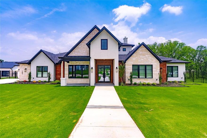 Welcome to Chelsea Rae Lane, a beautifully crafted custom home, nestled in the highly desirable Samantha Springs community of North Keller. This expansive single-story home offers 4 spacious bedrooms and 5 full bathrooms, designed with an open concept layout ideal for both everyday living and entertaining.
The chef inspired kitchen, complete with premium appliances, generous cabinetry, and a large central island with granite counter tops is perfect for cooking and gathering. Enjoy the seamless flow into the living and dining areas creating a warm, welcoming environment for hosting family and friends. The living area is anchored by a striking fireplace, adding warmth and elegance, perfect for cozy evenings. Large windows flood the home with natural light. The windows have been upgraded with classic plantation shutters, providing both elegance and light control throughout. Stepping into the luxurious primary bedroom is a true retreat, featuring a spa-like freestanding bathtub and custom built out closets designed for both style and organization.
One of the secondary bedrooms has been upgraded with full media equipment, including a projector, screen, and source components, ideal for a home theater experience. The backyard features lush landscaping surrounding a serene patio space complete with an outdoor grilling area, fireplace and covered seating. Situated on nearly an acre, the oversized lot provides ample space for future enhancements, recreation, or simply enjoying the peaceful setting. This home is a rare opportunity to own a thoughtfully designed, high-end property in one of North Keller’s most desirable communities.