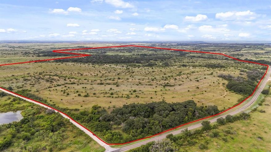 Beautiful 522+- acres with Warren Creek winding through. The native landscape offers great elevation changes providing views that you can see for miles and the possibility of several awesome building sites. There are beautiful live oaks, post oaks, and other hardwood trees adding to the privacy of the ranch and protection for the wildlife and livestock. Another amenity to this picturesque ranch is a watering tank for all animals and recreational fishing. The blank canvas of natural beauty allows for someone to build their own masterpiece. The possibilities are endless with this ranch......your forever home, hunting ranch, recreational ranch, great high fence potential, or combination of them all. The road frontage on two sides, with one being paved, allows great access. Come take a tour of the property and become an owner of a beautiful piece of Texas.  Will divide.