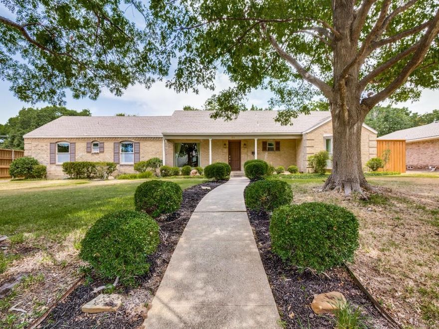 1- story home with beautiful wood floors, abundant natural light, and 4 generous Bedrooms; 2 with ensuite Baths and 2 share an updated Jack & Jill bath.  Primary Bedroom has room for a sitting area and has an updated Bathroom. Spacious, Updated Eat-In Kitchen with Custom Cabinets, upgraded Appliances,  Counter Top Seating that opens to Family Room with Fireplace. Large windows show off covered Flagstone Patio and large, fenced back yard. In addition to main house there is an attached Auxiliary Living unit with private entrance, Kitchenette, open Floor Plan, Private Bath, and separate WD connections; this area would be perfect for a private Home Office, Extended Family member, Staff or Babysitter dwelling, or large play area.  Oversized Carport area.  Small Workshop.  This home is located in a coveted Public School District with close access to Prestigious Private Schools. Convenient location allows quick access to Tollway, Preston Road, LBJ.  It's a great family home that must be seen to appreciate all the amenities and possibilities of lifestyle.