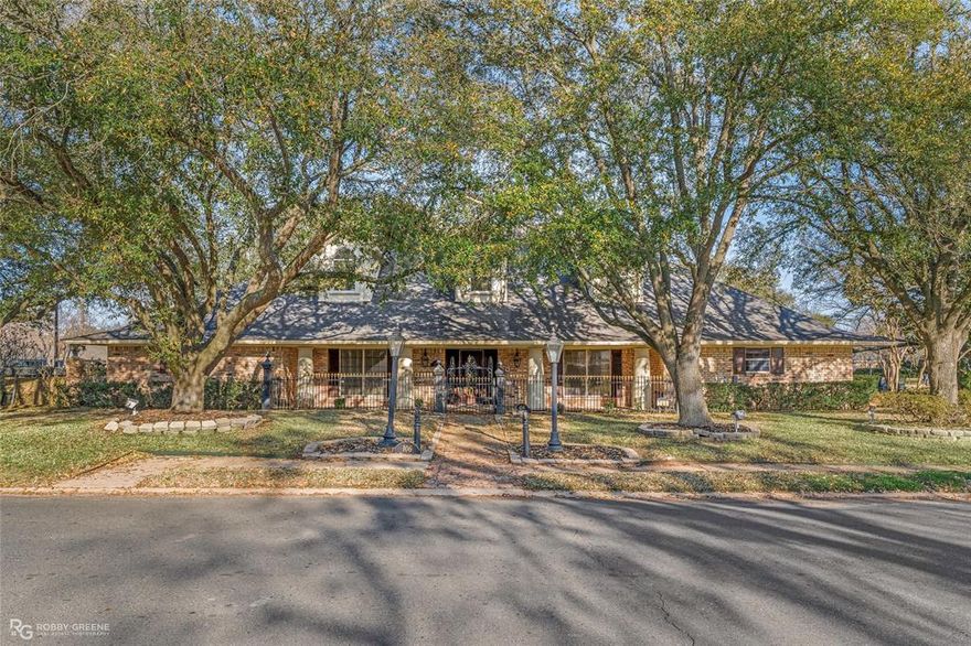 STOP THE SCROLL — Your Dream Home Has Arrived in Greenacres Place in beautiful Bossier City

Welcome to a residence where elegance meets everyday comfort. This stunning four bedroom, two and a half bath home sits on a spacious corner lot and blends luxury, warmth, and functionality in a thoughtfully designed single story layout.

Inside, expansive living areas are filled with charm and anchored by two fireplaces that create inviting gathering spaces. Gorgeous chandeliers throughout add refined character to every room.

With two dining areas, you can host formal dinners or enjoy relaxed family meals with ease. The kitchen and breakfast room serve as the heart of the home, featuring a wall of built in storage with a china cabinet and abundant counter space for both daily living and special occasions.

The primary suite is a peaceful retreat with a spa inspired bath, double vanities, and two walk in closets. Additional bedrooms offer generous space, and the fourth bedroom easily functions as a home office or flex space.

The fully heated and cooled sunroom seamlessly blends indoor and outdoor living, making it perfect for year round relaxation or entertaining.

Outside, the landscaped yard and beautiful fountain enhance the stately brick exterior. A bricked storage building and three car garage provide exceptional storage and convenience.

One of the most exciting features is the massive attic space that can be built out to create a dynamic home theater and exercise room or studio, offering incredible potential to expand and personalize.

This home delivers space, sophistication, and flexibility in one impressive package. Opportunities like this in Greenacres Place do not last. Schedule your private tour today.