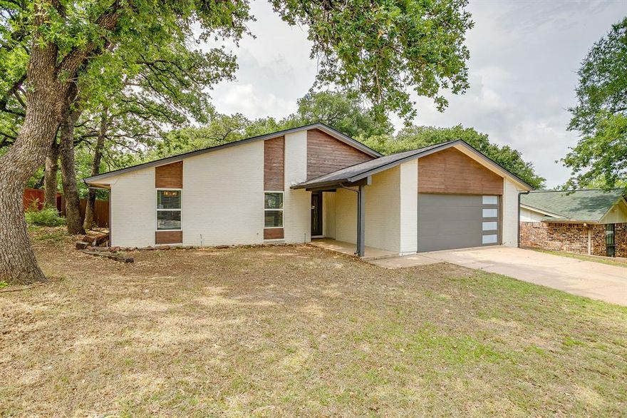Nestled on a large, tree-filled lot in an established Fort Worth neighborhood, this beautifully updated home offers the perfect blend of comfort, convenience and peace of mind. Ideally located just off I-30, the home provides quick and easy access to anywhere across the Metroplex—making commuting to Fort Worth, Arlington or Dallas a breeze. Inside, tasteful updates shine throughout, including fully remodeled bathrooms and a warm, inviting feel that is truly move-in ready. Even better, the major systems have already been taken care of for the next homeowner with a new roof and gutters, new HVAC system and new water heater already installed. Step outside to enjoy one of the property’s standout features—a massive backyard shaded by mature trees, with a privacy fence and an oversized deck built for entertaining, relaxing or enjoying quiet evenings at home. Whether hosting friends and family or simply enjoying the outdoor space, this backyard offers endless possibilities. First-time homebuyers rejoice! This home is an excellent opportunity for you or anyone looking for a well-maintained property with the expensive updates already completed. Combining location, updates and outdoor living space, this home is ready to welcome its next owner home.