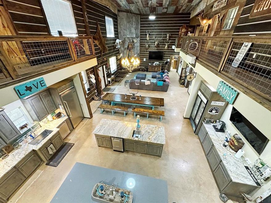 Video of stunning ranch @ YouTube, search Breaux Ranch 2026... Elegant 18-acre plus 17.33 acres with a 6-acre lake. Ranch is a sprawling property with endless possibilities! Additional acreage available.  The main house is a 6,519 sqft, 3 bed, 3.5 bath masterpiece (2020) that could easily be converted into 5 bedrooms if needed. The home features a rustic tin ceiling that came from the barn across from South Fork Ranch, industrial lighting from Harley Davidson Ft. Worth & 100+yr reclaimed wood which adds history & unique character. The guest house is a 1,100 sqft, 2 bed, 2 bath unit (2008 updated 2018). The property includes over 13000 sqft shop area, barns & horse stalls (spray foam insulated), RV storage, commercial tankless hot water, & soft water system. There is a 14'x25' indoor movie screen, 6+ car garage area & a solar panel system that basically eliminates electricity costs for the guest house. Pond with a waterfall, 3 hunting blinds there is ample space for outdoor activities. The ultimate chef's kitchen features Viking appliances, knotty alder cabinets, custom granite & island quartz countertops. I'm looking for a buyer for this stunning new ranch property. This one is truly a jaw dropper.