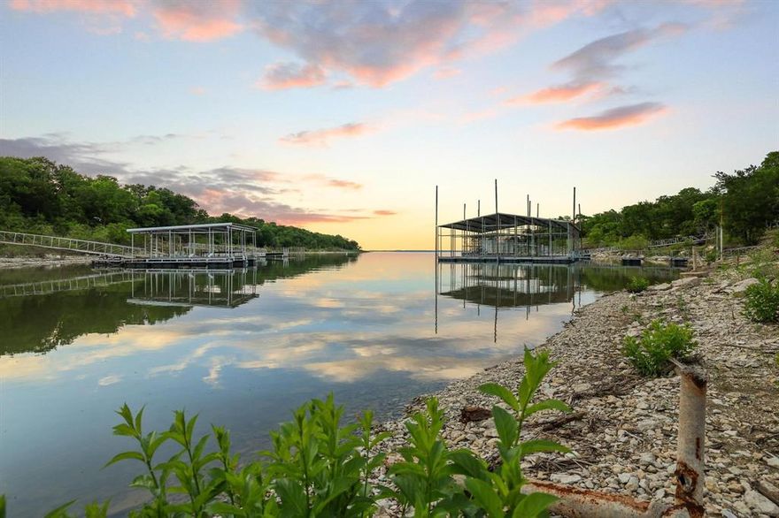 Situated on the third largest freshwater lake in Texas, you’ll find one of the RAREST lots on Lake Texoma! You will own all the way to the water’s edge with 181 feet of shoreline in a dockable cove all to yourself. Even better—approximately $125,000 worth of dirt work and land clearing has already been done for you, giving you a major head start. You can still dictate additional tree removal and truly make the property your own. This is an opportunity to create your family’s legacy lakefront estate with two homesites ready for your private family compound. Located outside of city limits with a low 1.61% tax rate, you’ll have the freedom to do what you want—plus free choice of builder. Water line is at the street, electricity is available; you’ll just need a septic system. You’re just 0.5 mile from Eisenhower State Park & Yacht Club, where you can rent boat slips, enjoy sandy beaches, plus miles of hiking, biking, ATV, and horse trails—and only 5 minutes from the Spillway Boat Ramp. While this property is tucked away near Ross Perot's Lake Texoma Estate, it is 2 miles away from the upcoming Preston Harbor community, which will offer lakefront dining options and the anticipated Margaritaville Resort. You’re surrounded by multimillion-dollar properties, including a neighboring home valued over $2M, and Denison’s highest-priced lake property at $10.9M right here in Thompson Heights—so you’re in very good company. The OPPORTUNITY to own lakefront property like this is NOW!