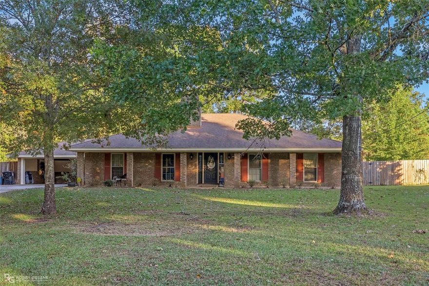 Welcome to this charming and spacious home nestled on 2.03 peaceful acres in Smithwood. From the moment you arrive, the beautiful brick exterior, inviting front porch, and mature trees create an ideal first impression.

Step inside to a welcoming foyer that leads to a large living room with vaulted ceilings, exposed beams, and a cozy brick fireplace. The perfect gathering space for family and friends. The home features 4 bedrooms , 2.5 baths with 2400sqft. has a formal dining room as well as a sun-filled breakfast area overlooking the backyard.

The kitchen offers generous cabinet space, double ovens. The primary suite provides comfort and privacy, while the additional bedrooms are spacious for guests, office, or hobbies.
Enjoy outdoor living on the covered patio and extended patio area, perfect for grilling or relaxing under the shade of the trees. The property also includes a workshop garage, ideal for projects, extra storage. A whole home generator provides peace of mind year round.
This home offers country living with convenient access to Minden’s shopping, and amenities. Minutes from I-20, Offering both space and comfort in a truly beautiful setting.