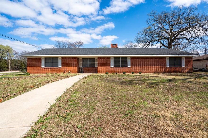 Discover comfort and space in this beautiful 3-bedroom, 3-bath brick home located just outside the loop in Paris, TX. Offering 2,412 square feet of living space, this property sits on a desirable corner lot with a large yard, mature trees, and a peaceful, quiet neighborhood setting.

Inside, you’ll find an updated kitchen featuring granite countertops, an oversized bar perfect for entertaining, and plenty of workspace. The spacious living room is warm and inviting with a cozy fireplace, ideal for relaxing evenings at home.

This thoughtfully designed layout includes two primary bedrooms, providing flexibility for multi-generational living or guest accommodations. All bedrooms are generously sized, and the home showcases tile and hardwood flooring throughout, along with a wide, welcoming hallway that enhances the open feel.

With its prime location, large lot, and move-in-ready updates, this home offers the perfect blend of comfort, style, and convenience. Don’t miss the opportunity to make it yours!