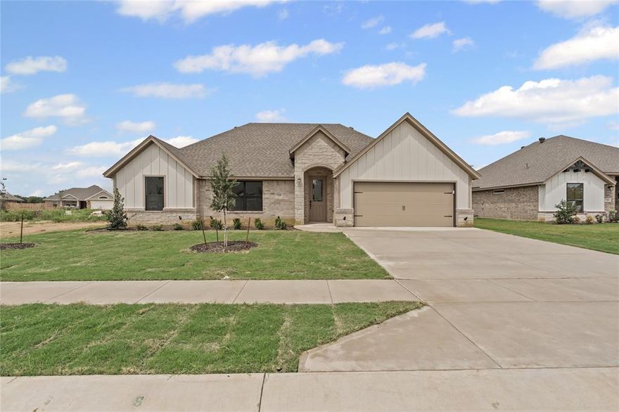 The builder is offering $5,000 in concessions toward closing costs, a rate buy-down, or however you'd like to use it. Welcome to your dream modern farmhouse in the sought-after Boardwalk Estates, expertly built by Al Couto Homes. This energy-efficient home combines timeless style with everyday comfort, featuring spray foam insulation, a Trane HVAC system with a heat pump, and a finished garage with epoxy flooring, prepped for your electric vehicle charger. Inside, you'll love the open floor plan, soaring ceilings, and beautiful wood-look tile floors that flow throughout the home. The inviting living room with coffered ceilings is anchored by a cozy stone fireplace, perfect for relaxing or entertaining. The heart of the home is the chef-inspired kitchen, complete with quartz countertops, stainless steel appliances, an abundance of custom cabinetry, a walk-in pantry, and a spacious dining area overlooking the fully fenced backyard. Your private owner’s suite retreat includes a spa-like bathroom with dual vanities, a walk-in shower, a soaking tub, and an impressive walk-in closet with built-in shelving and floor-to-ceiling rods. The split-bedroom layout offers privacy for the secondary bedrooms. The spacious laundry room adds extra storage and convenience. Step outside to a covered patio perfect for outdoor entertaining or unwinding after a long day, with electrical already installed for your future TV. With no HOA and a low property tax rate, this home offers both luxury and long-term affordability in a prime location.
